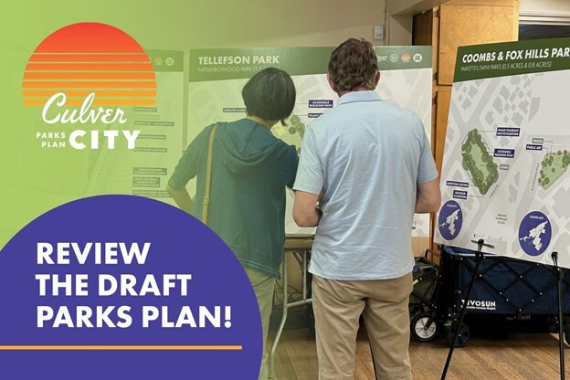 Two citizens look at parks plan posters for Tellefson Park