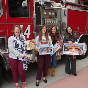 Photos of people holding toys for Spark of Love Toy Drive