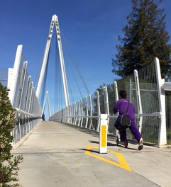 Boy on scooter on bridge