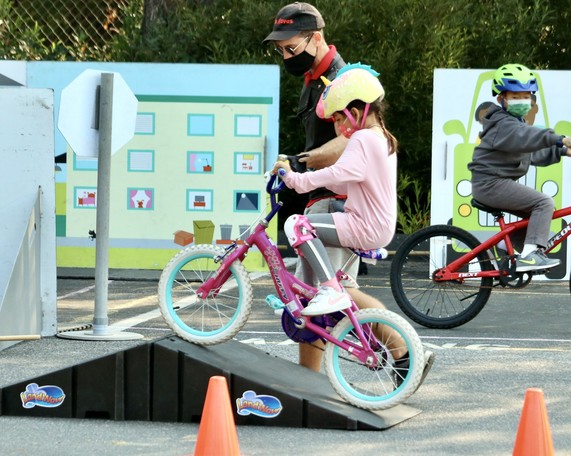 small cyclist on obstacle course