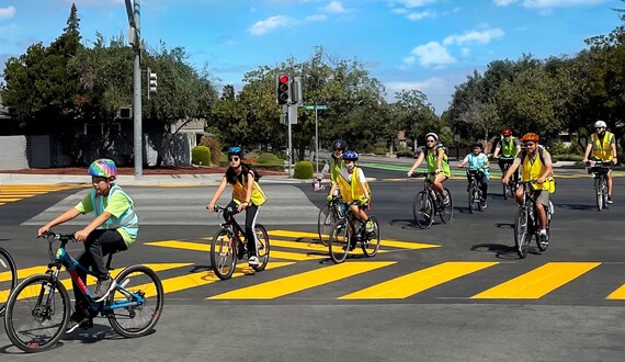 group biking through an intersection