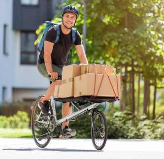 man carrying boxes by bike