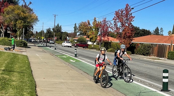 two boys cycling in separated bike lane