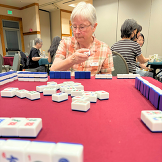 Senior Center participant plays mahjongg at Mid-Autumn Festival event