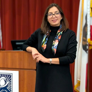 Newly appointed City Manager Tina Kapoor leaning against Cupertino podium