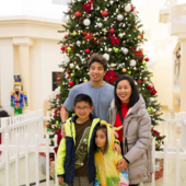 Family in front of the Quinlan holiday tree