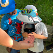 Kids looking though a magnifying-glass 