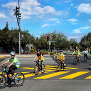 Families learning to ride on bicycles in streets