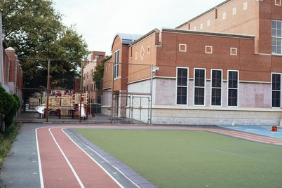 Generic stock photo of an outdoor school campus building and playground 