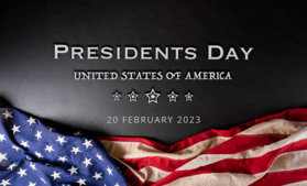American Flag laying on top of plaque stating "Presidents Day"