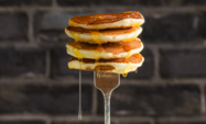 pancakes dripping with syrup on a fork