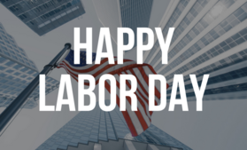 Corporate buildings with American flag and words "Happy Labor Day"