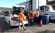 EDCO employees accepting shred boxes from cars