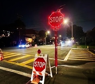 New stop sign at night on the corner of Oak and Main