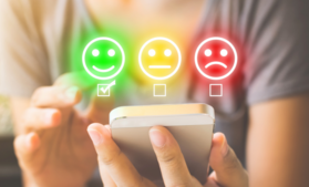 Person on phone selecting a happy face, next to neutral and sad faces