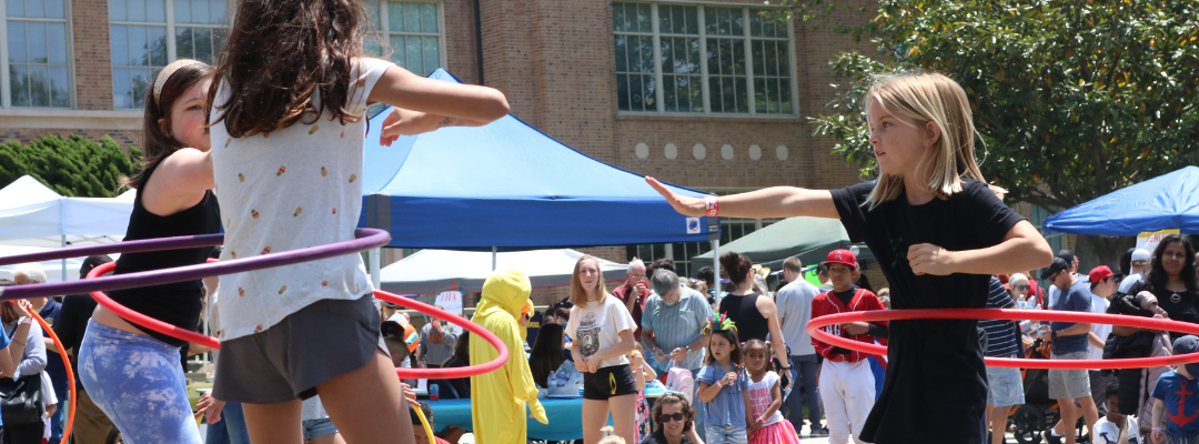 Girls hula hooping together in front of El Segundo High School at the Hometown Fair