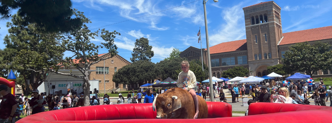 Girl on a bullride in front of El Segundo High School at the Hometown Fair