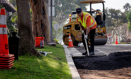 El Segundo member of public works resurfacing a residential street