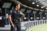 Female police officer holding a golf club at Topgolf