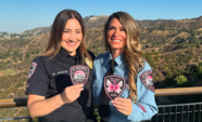 ESPD officers holding 2024 breast cancer awareness pink patches