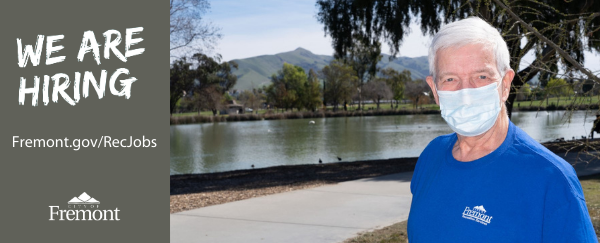 man in front of lake and trees