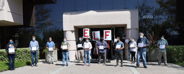 graduates from ELF Program standing in front of building