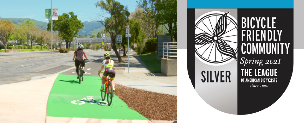 two woman biking on street and award badge