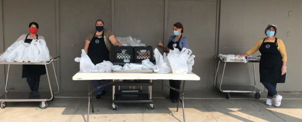 people standing with bags of food