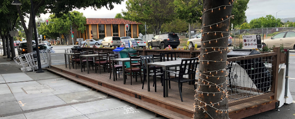 outdoor tables and chairs on sidewalk
