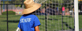 employee in hat behind the net