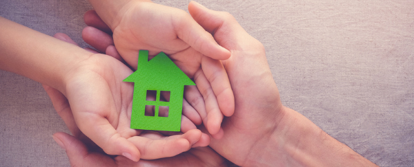 hands holding a small green house item