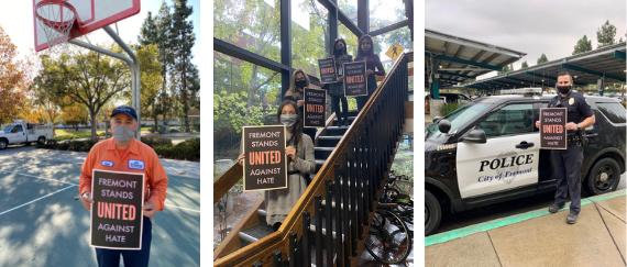 City employees holding 'Fremont Stands United Against Hate' posters