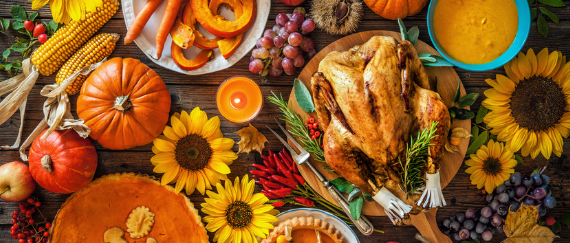 Thanksgiving food on the table with turkey, pie, fruits, vegetables