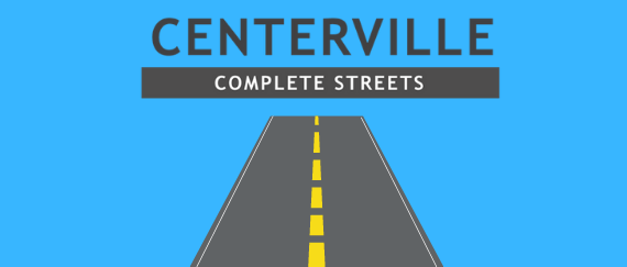 gray street with yellow dotted lines in center with text