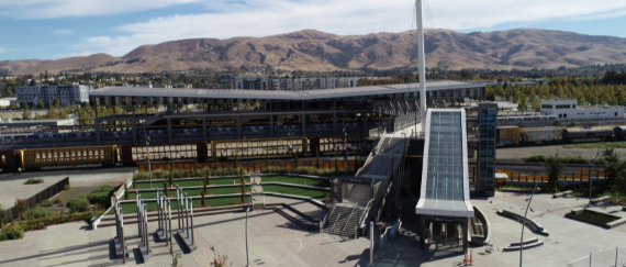 West Access Bridge and Warm Springs Plaza at BART Station, hills, train