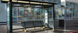 bus shelter with bench, cover, garbage can, artwork on windows