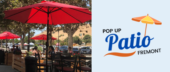 outdoor dining on sidewalk with umbrella, table, and diners