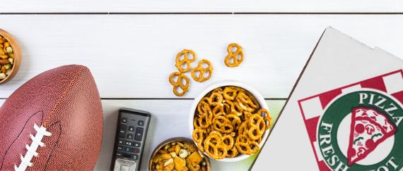 football, TV remote control, pretzels, and pizza box