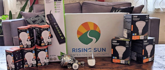 LED light bulbs standard and floodlight, smart power strip, faucet aerators, high efficiency showerhead on a coffee table and couch