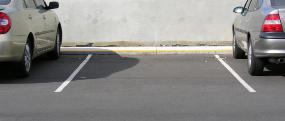 two cars parked in parking stalls
