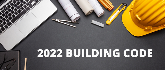 laptop, plans, tools, hardhat and 2022 Building Code text