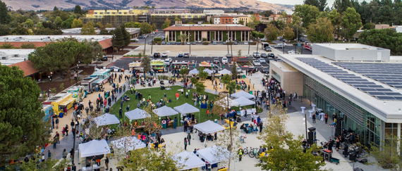 aerial of Downtown Event Center and Plaza event with booths, food trucks, and buildings