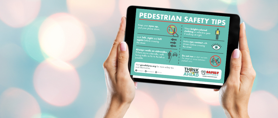 hands holding table with Pedestrian Tips listed and in text with background colorful lights