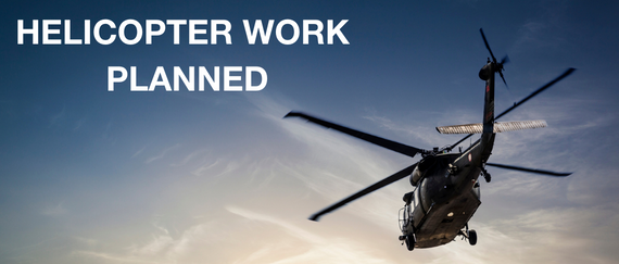 helicopter flying in blue sky. Helicopter Work Planned in text