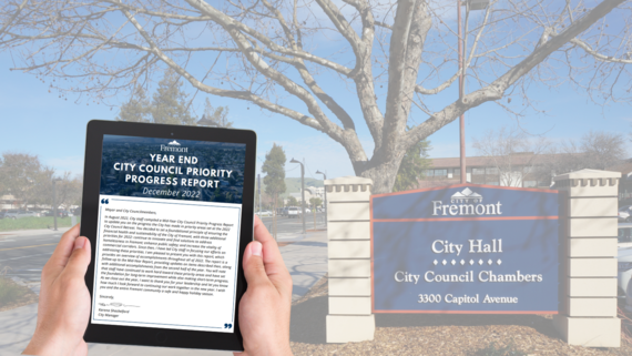 tablet with report displaying and City Hall sign in parking lot