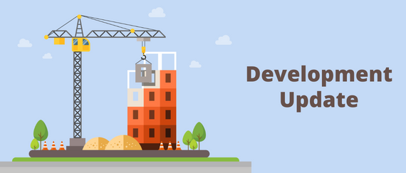 building, crane, safety cones, tree. Development Update in text