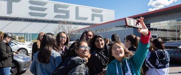 Girls Take Selfie in front of Tesla Building