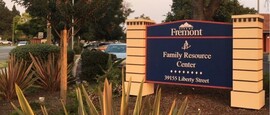 Family Resource Center exterior sign with plants and shrubs
