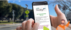 hands holding smart phone with AC Transit survey on screen with street and street signs in background