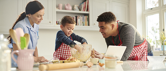 family in the kitchen cooking a meal together